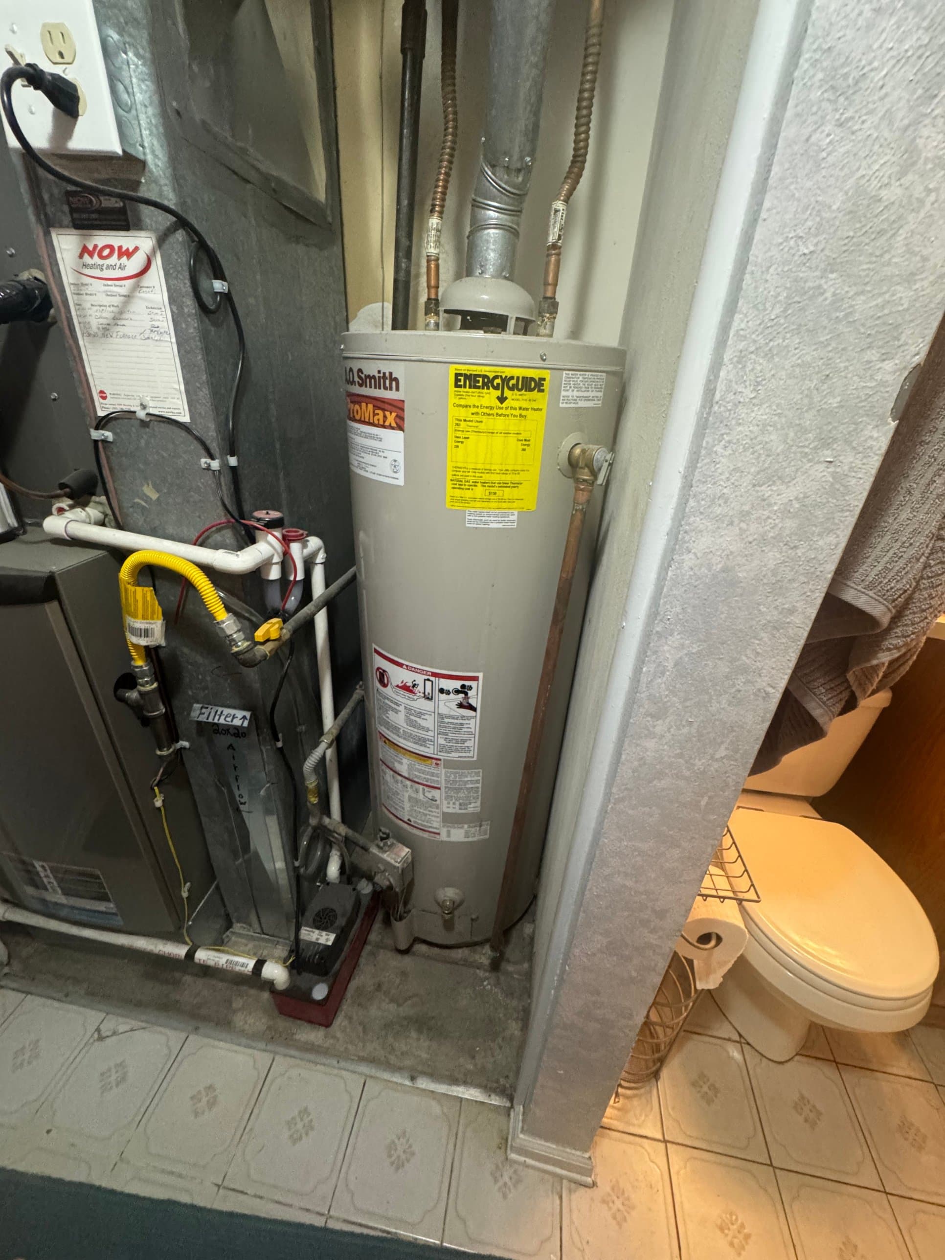 Water heater repair service in Aurora, CO — A.O. Smith ProMax tank water heater installed in a residential utility closet serviced by Zenith Home Services